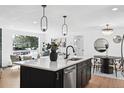 Bright kitchen with island, stainless steel appliances, and view to living space at 290 Beryl Way, Broomfield, CO 80020