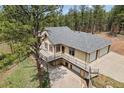 Beautiful home with large deck, multi-car garage, mature trees and lush green lawn at 510 Hill Dr, Sedalia, CO 80135