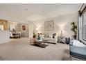 Bright living room with neutral carpet, dining area, and stylish decor at 9160 E Arbor Cir # F, Englewood, CO 80111