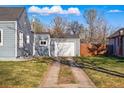 Detached garage accessible by a long driveway, surrounded by lush lawn at 4720 Perry St, Denver, CO 80212