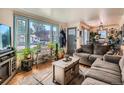 Cozy living room featuring hardwood floors, abundant natural light, and comfortable seating arrangements at 3645 S Fox St, Englewood, CO 80110