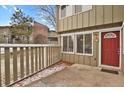 Exterior of condo features a red door and maintained front patio area at 857 S Van Gordon Ct # H101, Lakewood, CO 80228