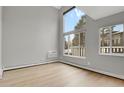 Bright, empty living room with hardwood floors and ample natural light from large windows at 857 S Van Gordon Ct # H101, Lakewood, CO 80228