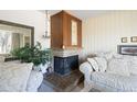 Comfortable living room showing fireplace with traditional mantel, neutral carpet, and large mirror at 1288 S Drexel Way, Lakewood, CO 80232