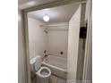 Bathroom with tile floor, combination tub and shower, and toilet at 8826 E Florida Ave # 204, Denver, CO 80247