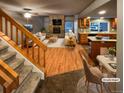 Open living room and kitchen with hardwood floors, fireplace, and staged furniture at 442 S Kalispell Way # C, Aurora, CO 80017