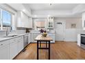 Bright kitchen features white cabinets, stainless steel appliances, and a butcher block island at 7996 Bradburn Blvd, Westminster, CO 80030