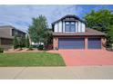 Inviting two-story home with a three-car garage, a well-kept lawn, and mature trees at 1175 Oakhurst Dr, Broomfield, CO 80020