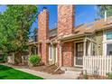 Beautiful exterior view with well-manicured lawn, complemented by a brick chimney and freshly painted facade at 14093 E Radcliff Cir, Aurora, CO 80015