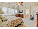 Spacious main bedroom with en-suite bathroom, large windows, and neutral decor at 17613 E Peakview Ave, Aurora, CO 80016