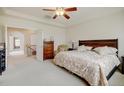 Bright main bedroom featuring a tray ceiling, neutral color palette, and an ensuite bathroom at 17613 E Peakview Ave, Aurora, CO 80016