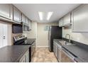Efficient kitchen featuring modern appliances, gray cabinets, and sleek countertops for a contemporary look at 4400 S Quebec St # 108L, Denver, CO 80237