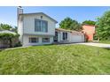 Traditional two-story home featuring a manicured lawn and attached two car garage at 4416 E 93Rd Pl, Thornton, CO 80229