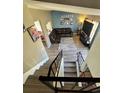 A view from the upper level down to the living room with stylish floors and decor at 4416 E 93Rd Pl, Thornton, CO 80229