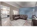 Inviting living room with a modern leather sofa and neutral colored walls at 4416 E 93Rd Pl, Thornton, CO 80229