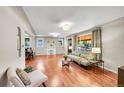 Spacious living room features hardwood floors, a decorative fireplace, and large windows at 4268 S Delaware St, Englewood, CO 80110