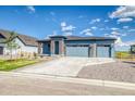 Attractive single-story home with three-car garage, rock details, and wide driveway at 39210 Anthony St, Elizabeth, CO 80107