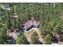 Stunning aerial view of a home surrounded by tall, lush green trees at 4726 Pinon Dr, Elizabeth, CO 80107