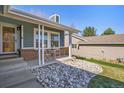 Inviting front porch with stylish seating and a decorative rock garden at 482 Southpark Rd, Highlands Ranch, CO 80126