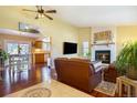 Open-concept living room with fireplace and adjacent dining area at 482 Southpark Rd, Highlands Ranch, CO 80126