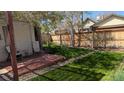 Secluded backyard featuring a wooden fence, small deck, and lush green grass at 2377 Cherry St, Denver, CO 80207