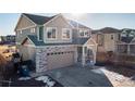 Two-story house with stone accents and a two-car garage at 16508 E 111Th Pl, Commerce City, CO 80022