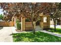 Inviting brick home with front porch and mature trees, enhancing its curb appeal at 2549 Holly St, Denver, CO 80207