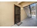 Entrance of condo with decorative security door, staircase, and a welcome mat at 9700 E Iliff Ave # B13, Denver, CO 80231
