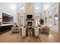 Spacious living room featuring vaulted ceilings, a stone fireplace, and large windows for natural light at 2130 Avenida Del Sol, Castle Rock, CO 80104