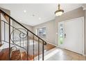 Bright entryway featuring tile floors, decorative staircase and a window, creating an inviting welcome at 6545 S Balsam Ct, Littleton, CO 80123