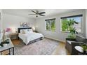 Inviting bedroom featuring hardwood floors, a ceiling fan, and large windows offering ample natural light at 1376 Ivanhoe St, Denver, CO 80220