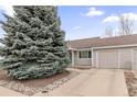 Residential house featuring an attached garage, concrete driveway, and mature landscaping at 1424 S Sierra Dr, Castle Rock, CO 80104