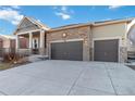 Well-maintained single-Gathering home with stone facade, a covered porch, and a three-car garage on a sunny day at 1588 Blackwood Ct, Erie, CO 80516