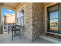 Cozy front porch with stone accents, seating, and a welcoming entrance to this charming single-Gathering home at 1588 Blackwood Ct, Erie, CO 80516