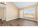 Well-lit room showcasing hardwood flooring, a large window, and neutral walls at 1603 S Flanders Way, Aurora, CO 80017