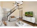Bright living room featuring a staircase with wooden rails, hardwood floors, and a contemporary design at 1603 S Flanders Way, Aurora, CO 80017
