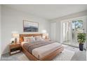 Bright main bedroom featuring a sliding glass door and stylish decor at 6705 S Field St # 803, Littleton, CO 80128