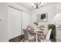 Cozy dining area featuring a round table, chandelier, and closet space at 6705 S Field St # 803, Littleton, CO 80128