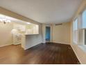 Bright living room with white kitchen view and hardwood flooring at 6705 S Field St # 803, Littleton, CO 80128