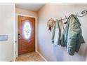 Inviting entryway with a decorative front door, ceramic tile flooring, and a coat rack at 2863 S Biscay Ct, Aurora, CO 80013