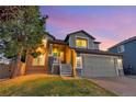 Charming two-story home with an attached two-car garage, lush lawn, and welcoming front porch at 17166 Yellow Rose Way, Parker, CO 80134