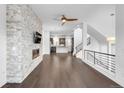 Spacious living room with stone accent wall, modern fireplace, and beautiful hardwood floors at 6485 E Cedar Ave, Denver, CO 80224
