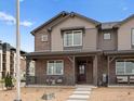 Attractive two-story townhome with brick and siding, plus a charming front porch at 20802 E 66Th Ave, Aurora, CO 80019