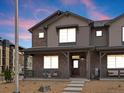 Inviting two-story townhome with brick and siding exterior and covered front porch at 20802 E 66Th Ave, Aurora, CO 80019