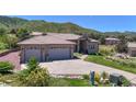 Charming single-story house with a three-car garage, well-manicured lawn, and picturesque mountain views at 10950 Elk Horn Run, Littleton, CO 80125