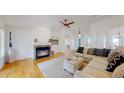 Bright living room featuring a fireplace, hardwood floors, and modern decor at 10950 Elk Horn Run, Littleton, CO 80125