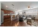 Open concept living and dining areas with hardwood floors and light gray furnishings at 4474 Copeland Cir # 102, Highlands Ranch, CO 80126