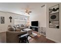 Cozy living room features a ceiling fan, window blinds, and decorative wall art at 4474 Copeland Cir # 102, Highlands Ranch, CO 80126
