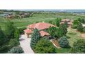 Aerial view of beautiful home displays well-manicured lawn, lovely landscaping, and large driveway with spacious two car garage at 5603 Twilight Way, Parker, CO 80134