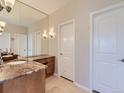 Bathroom featuring dual doors, large mirror and granite countertops at 5603 Twilight Way, Parker, CO 80134